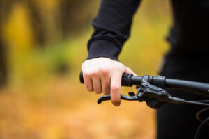 Biker's hand on the handlebars close up