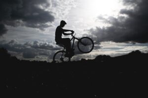 A man doing a wheelie on the bike