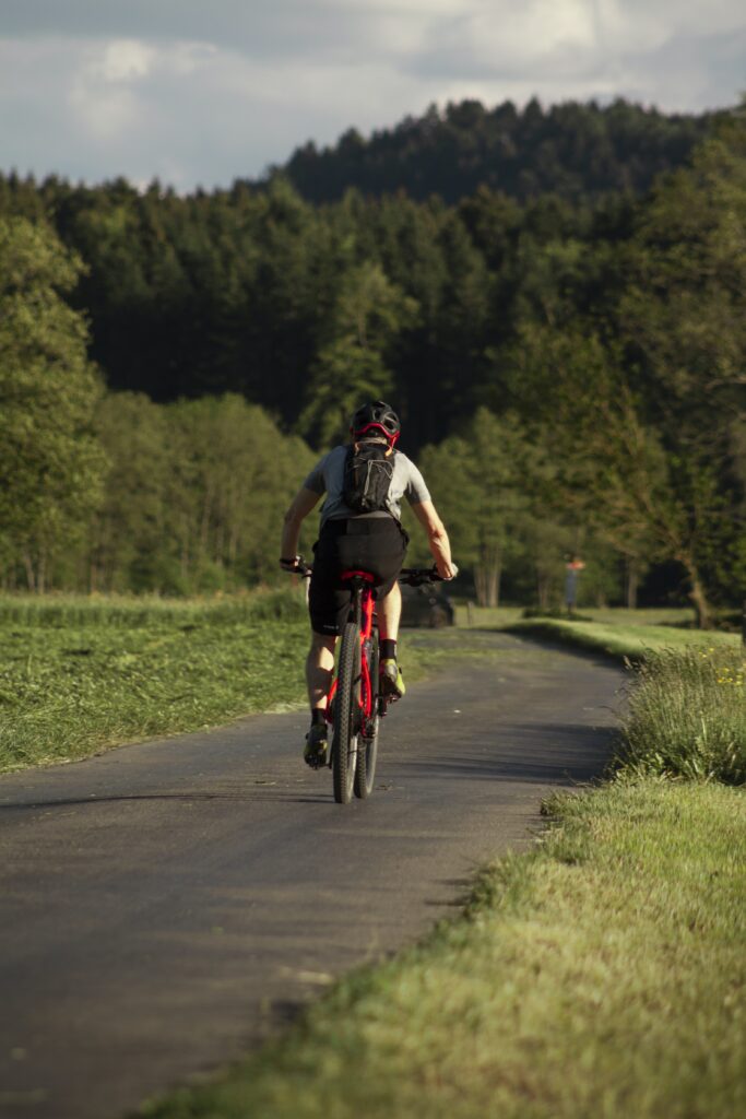 A man riding a mountain bike in the road